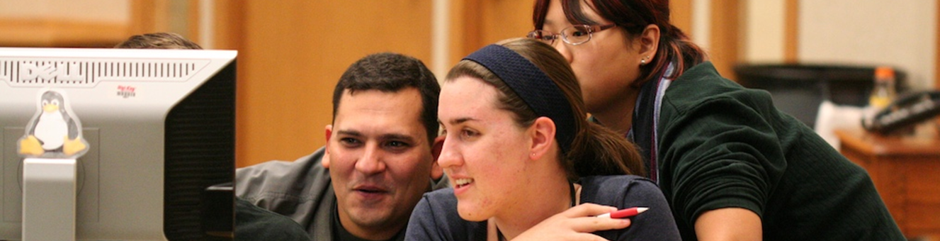 Four students collaborating on a computer