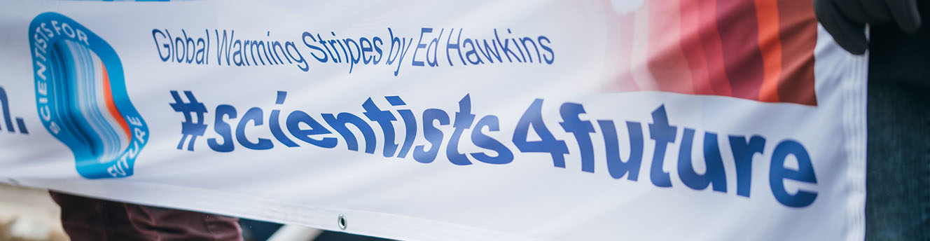 Protesters holding a banner with #scientists4future hashtag